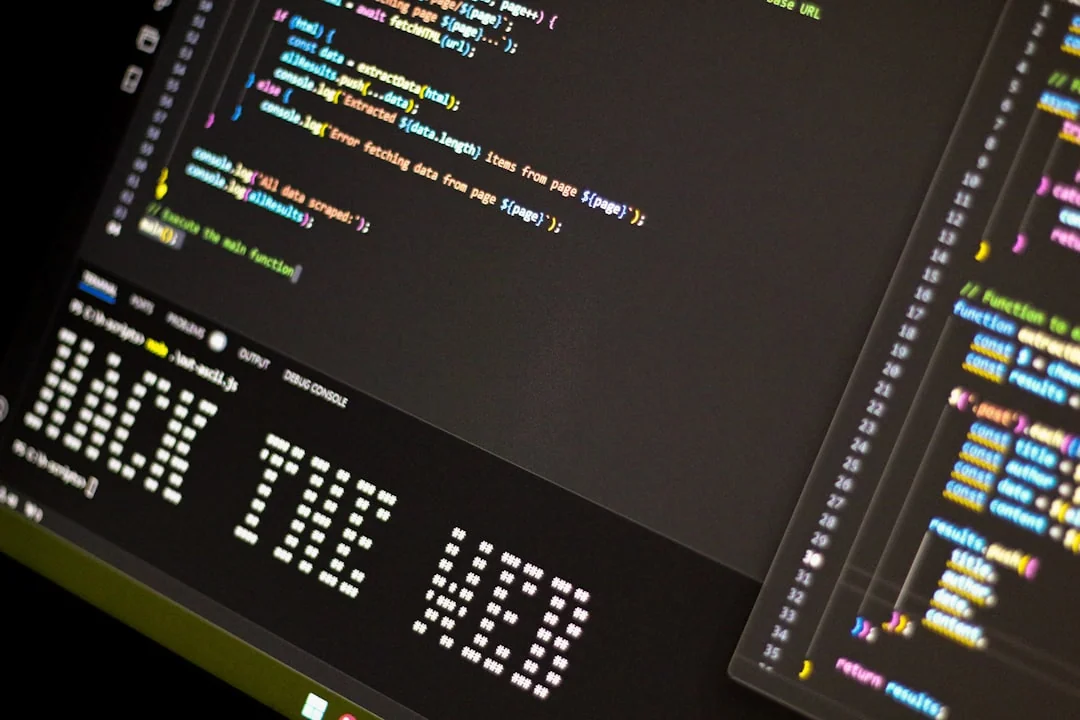 A laptop screen shows a coding application with a calculator design in a tech office setting.